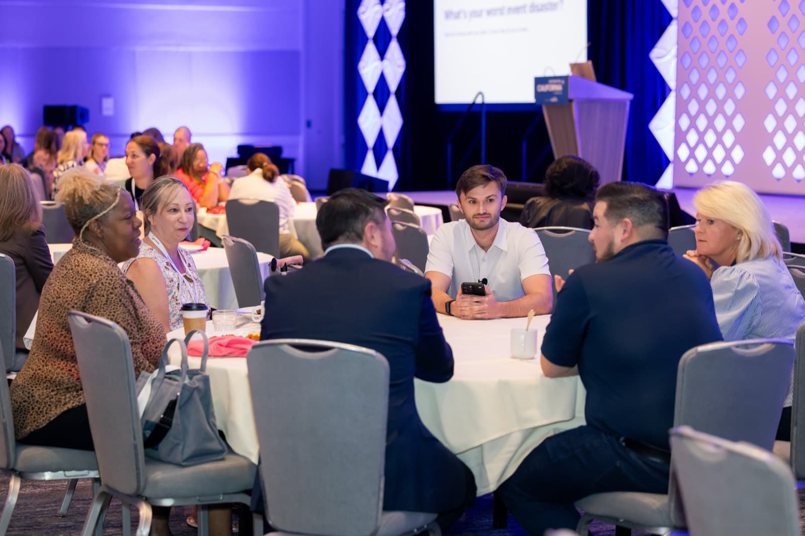 Noah Cheyer sitting with a table of event professionals working through their own workflows at Destination California by Northstar Meetings Group