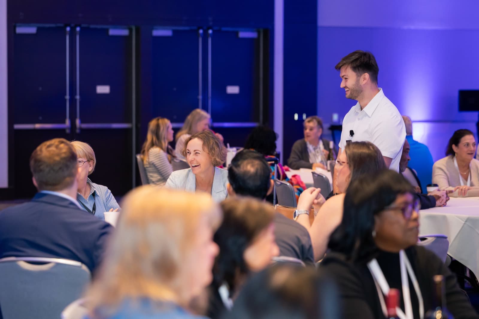 Noah Cheyer talking with event professionals at their table during a working session at Destination California by Northstar Meetings Group